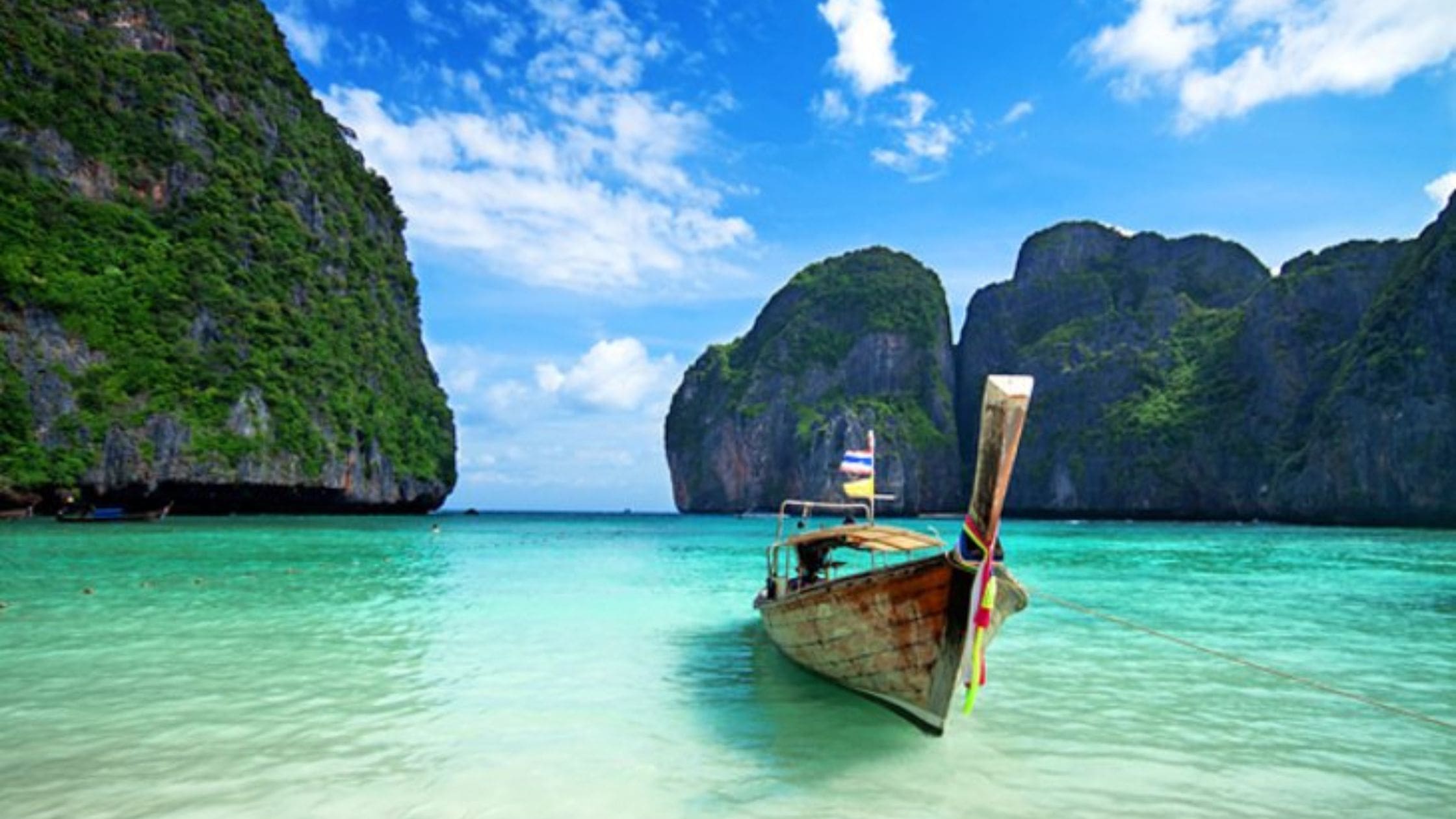 Scenic view of Phuket Island, Thailand with turquoise water and lush greenery.